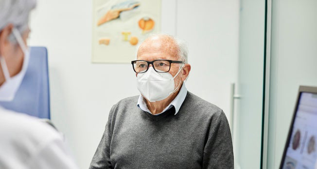 COVID-19 patient reviewing medications with healthcare provider