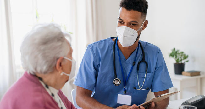 patient with COVID-19 with doctor considering oral treatment